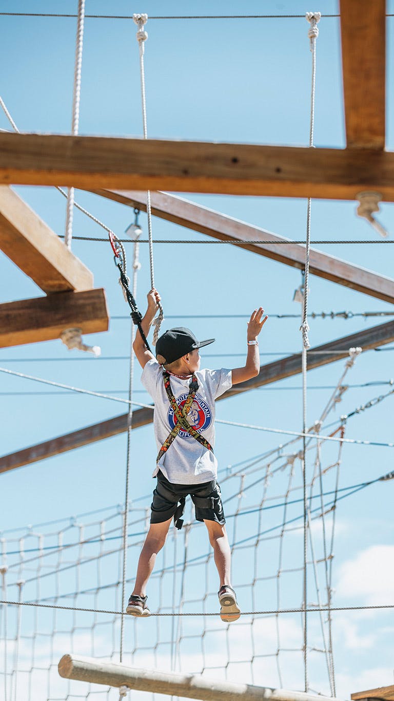 Boy on the Mammoth Mountain ropes course.