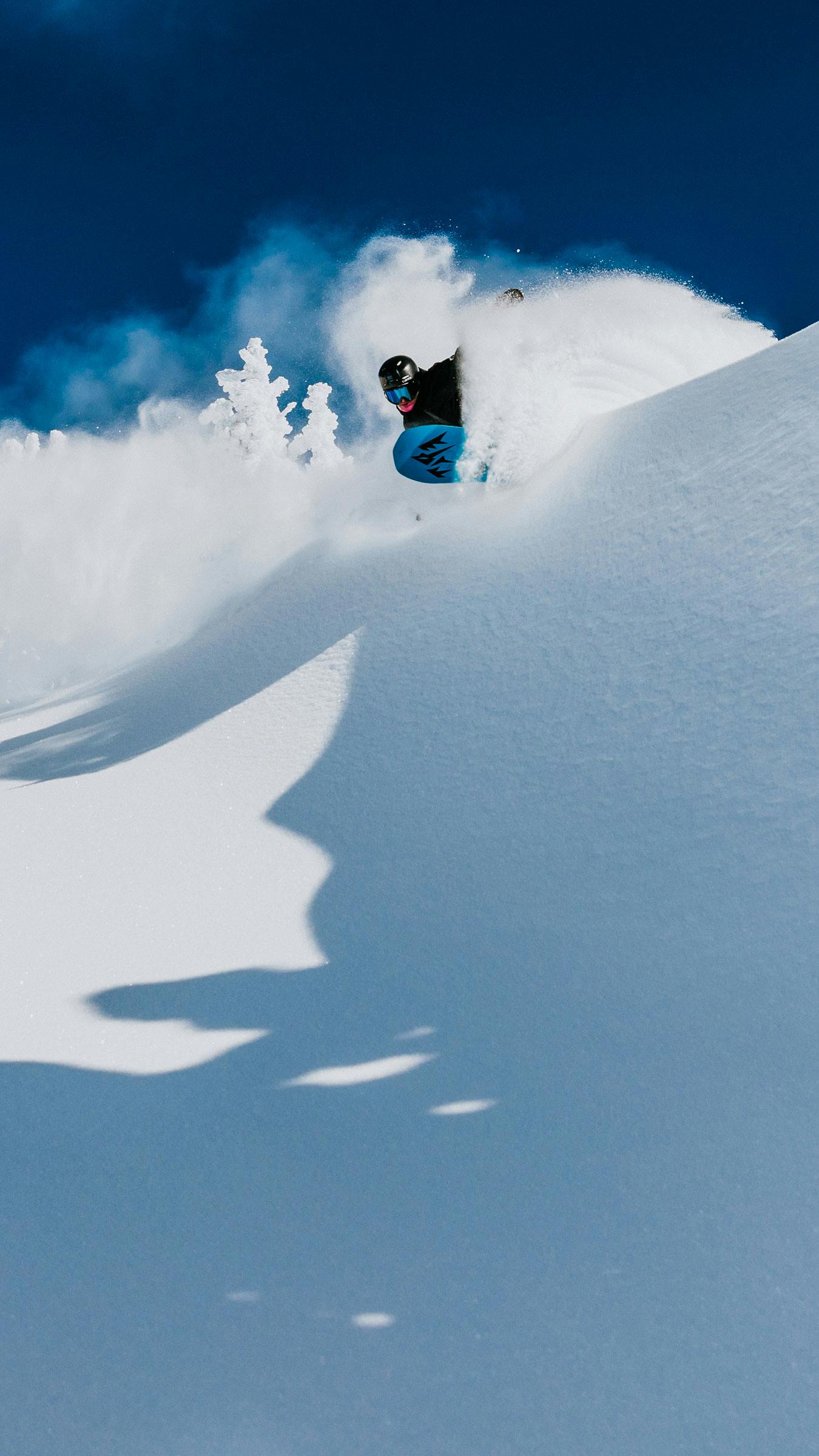 Snowboarder enjoys bluebird powder day