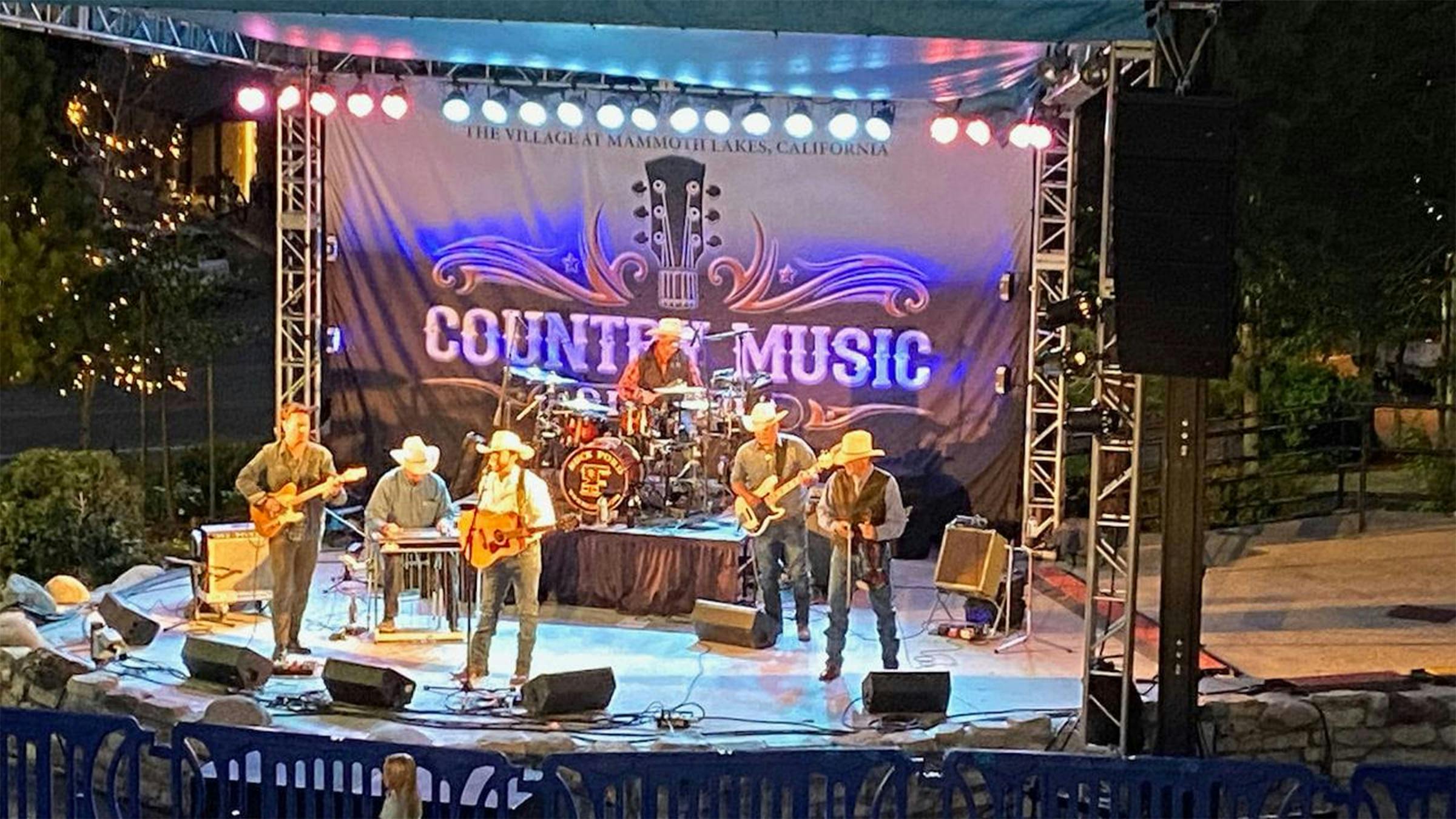 Band playing live country music on stage at The Village at Mammoth