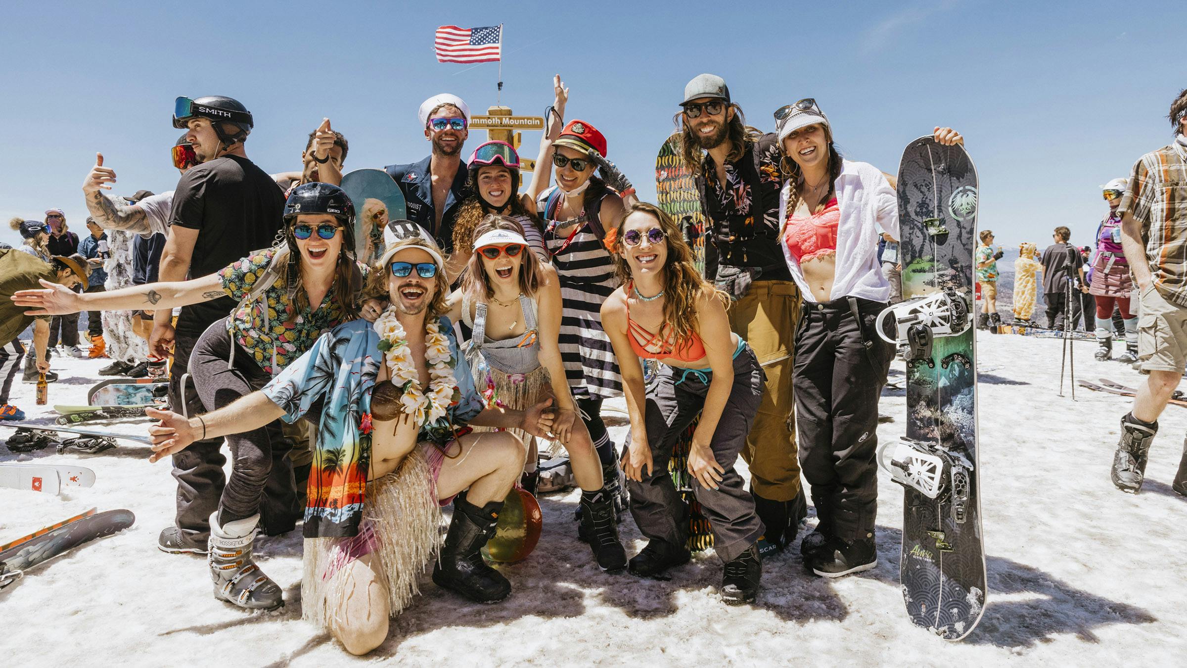 Group of friends posing for a photo at summit of Mammoth Mountain in summer attire for Mammoth Yacht Club
