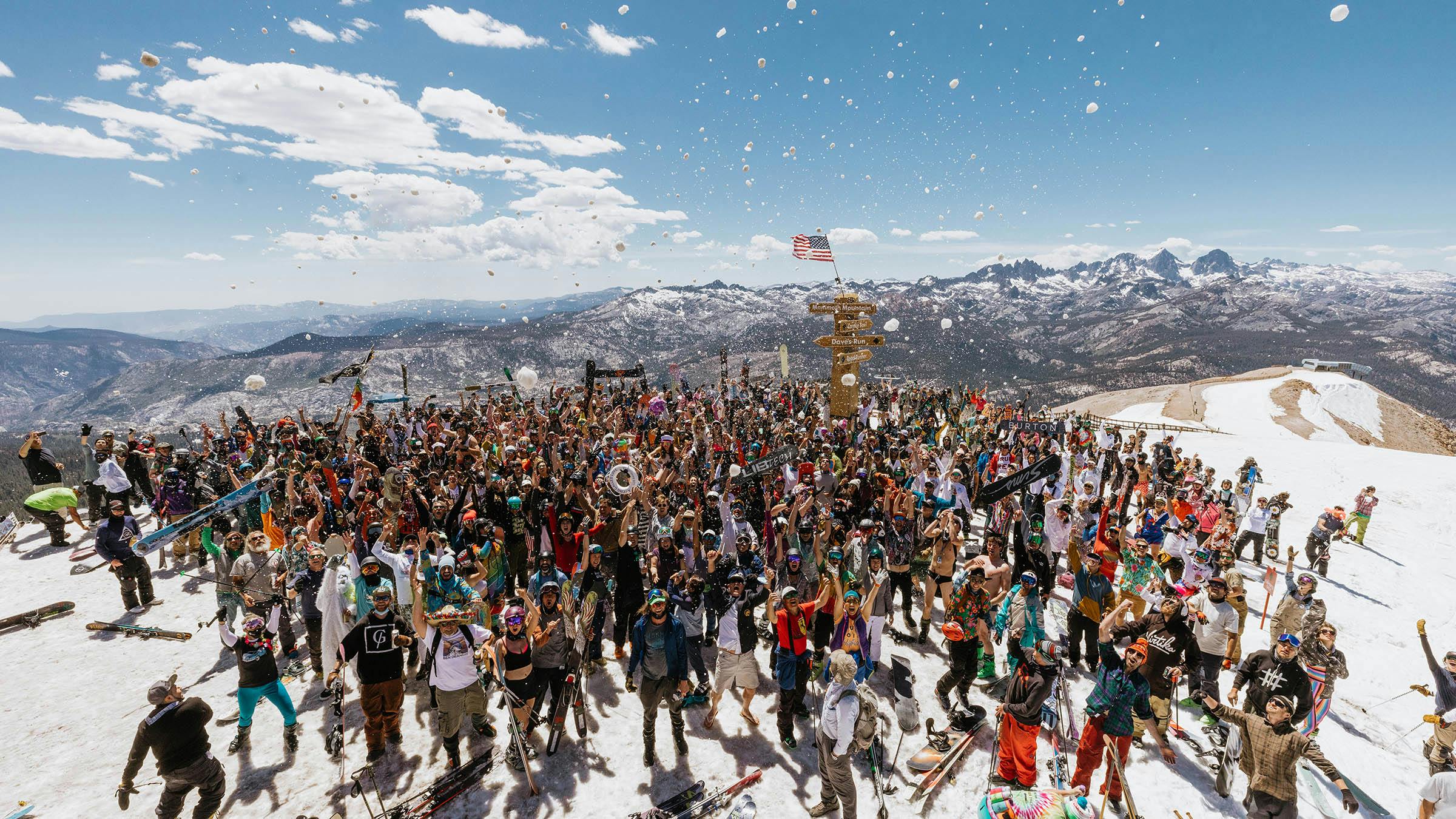 Large crowd posing for group photo on top of Mammoth Mountain for Mammoth Yacht Club Weekend