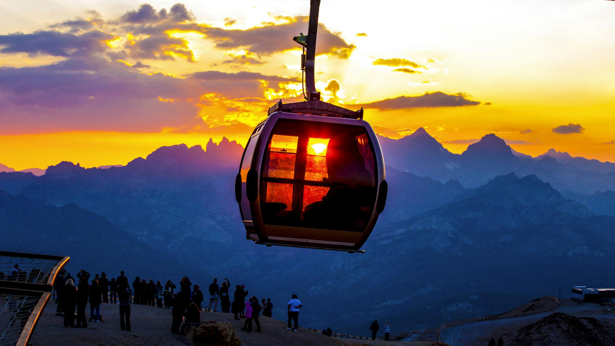 Mammoth Mountain's Panorama Gondola car with sun setting over the Minarets in the background