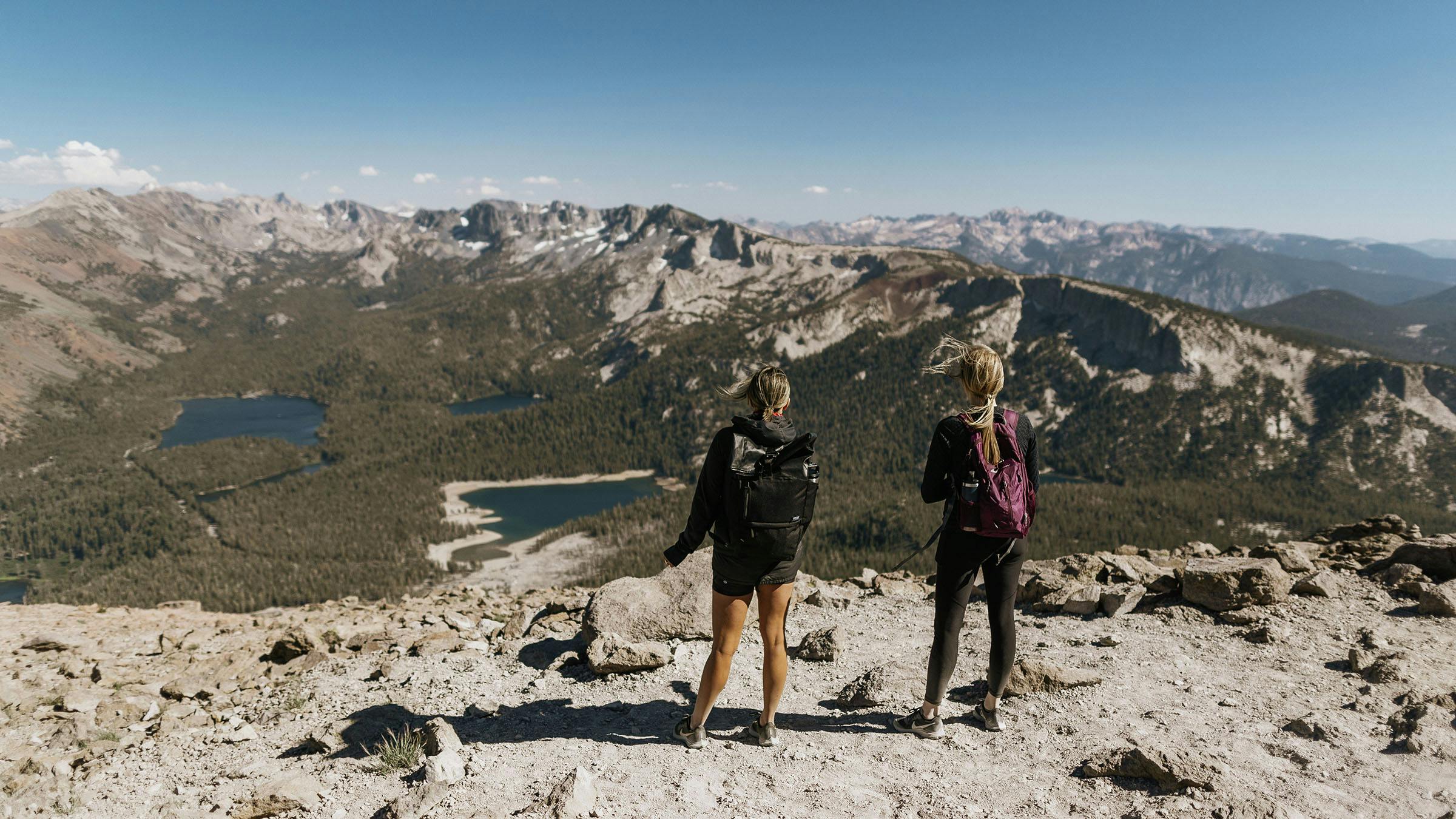 Two women looking out at the Lakes Basin from the overlook on the top of Mammoth Mountain