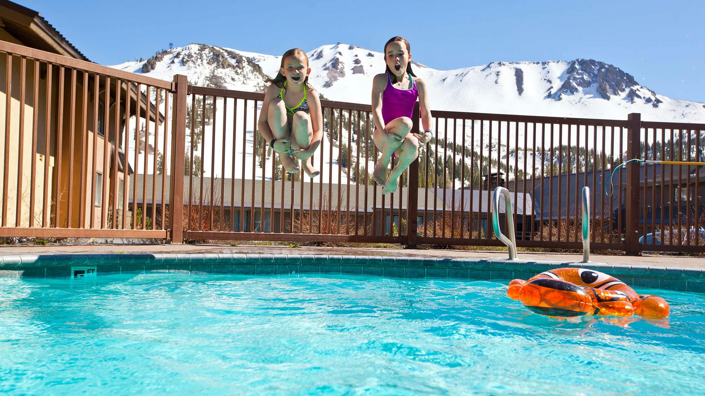 Two girls swimming at MMI with Mammoth Mountain in the background