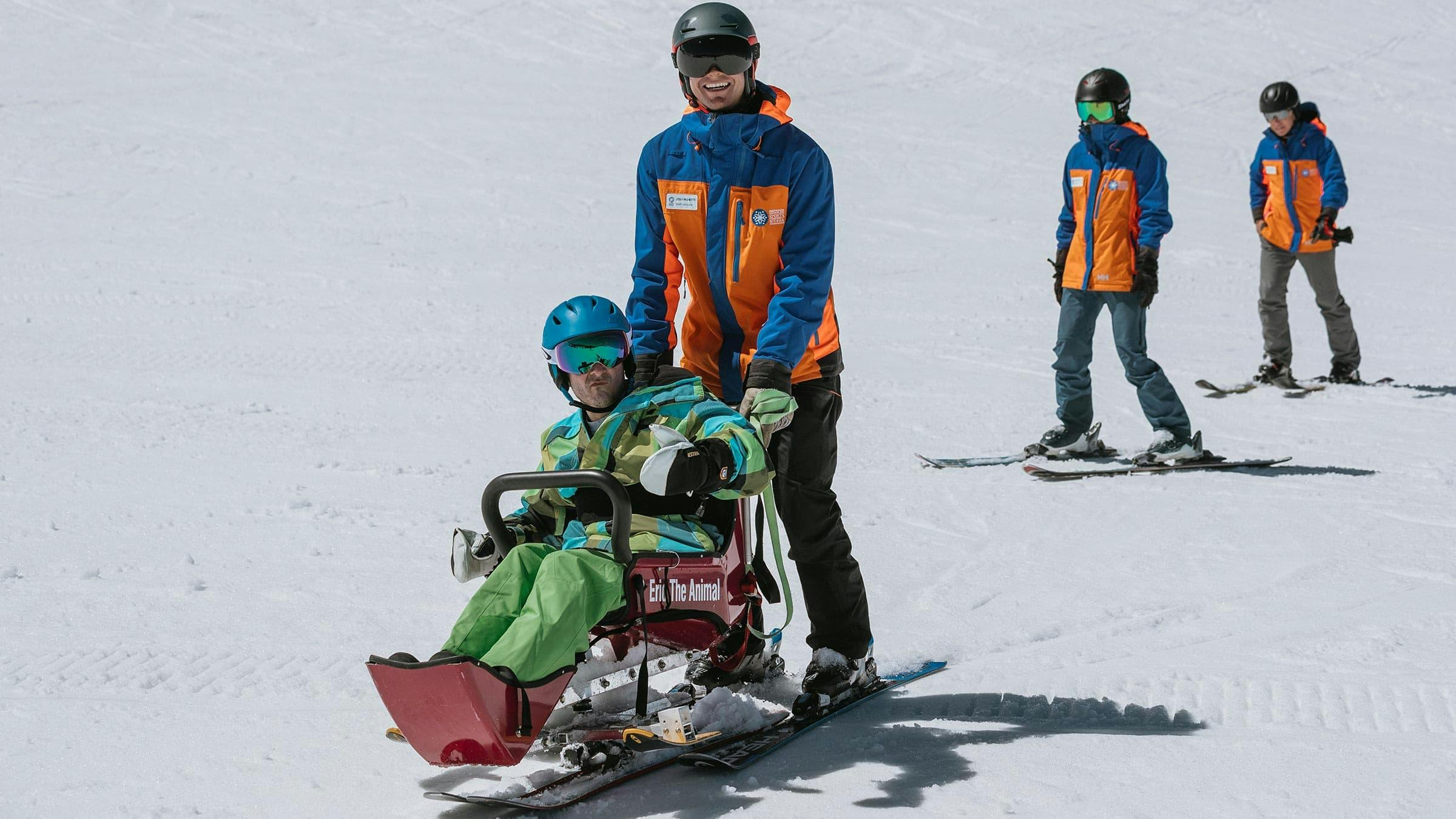 Disabled Sports of Eastern Sierra guiding an adaptive skier