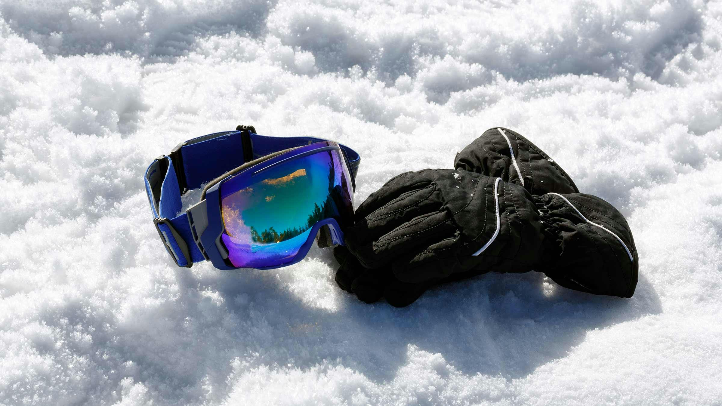 goggles and gloves on snow