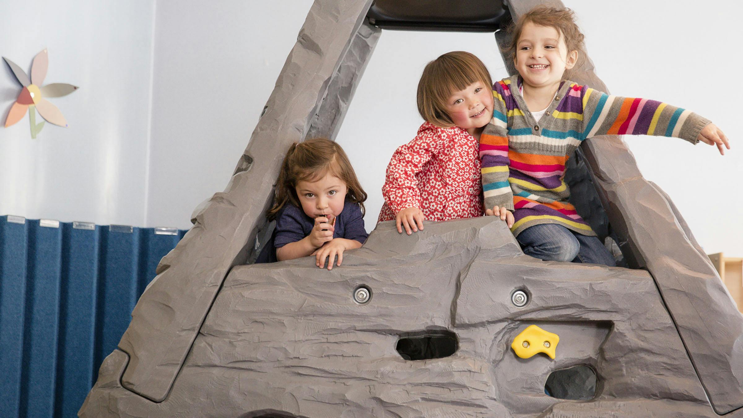 Group of three kids playing at daycare