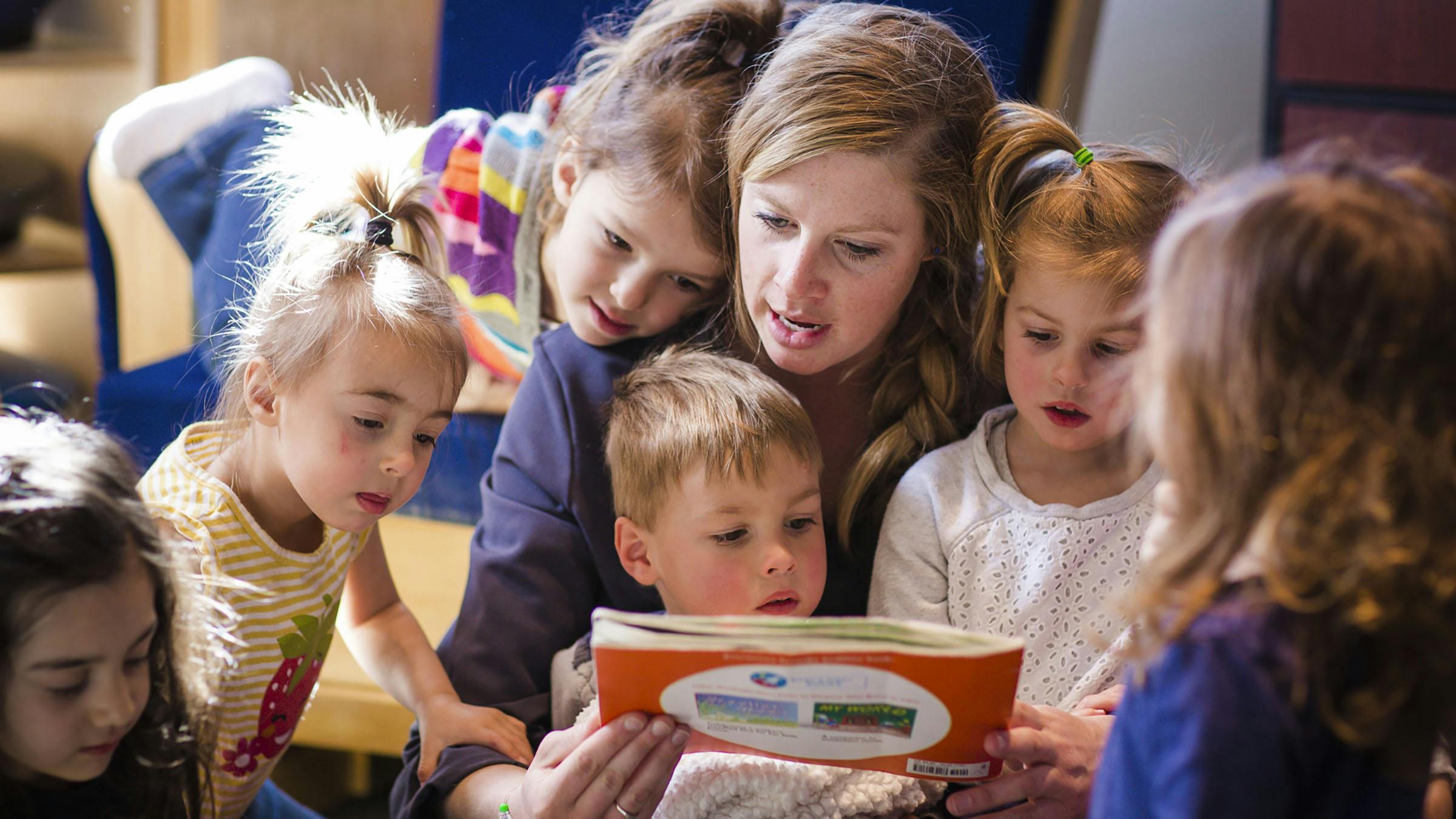 Daycare instructor reading to children