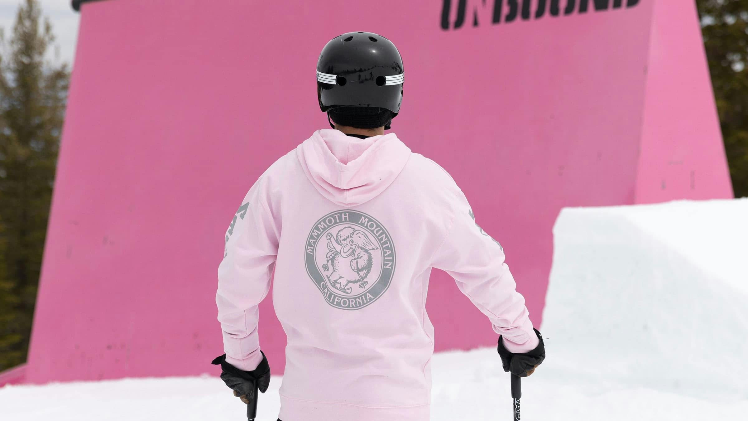 skier wearing a pink Mammoth hoodie