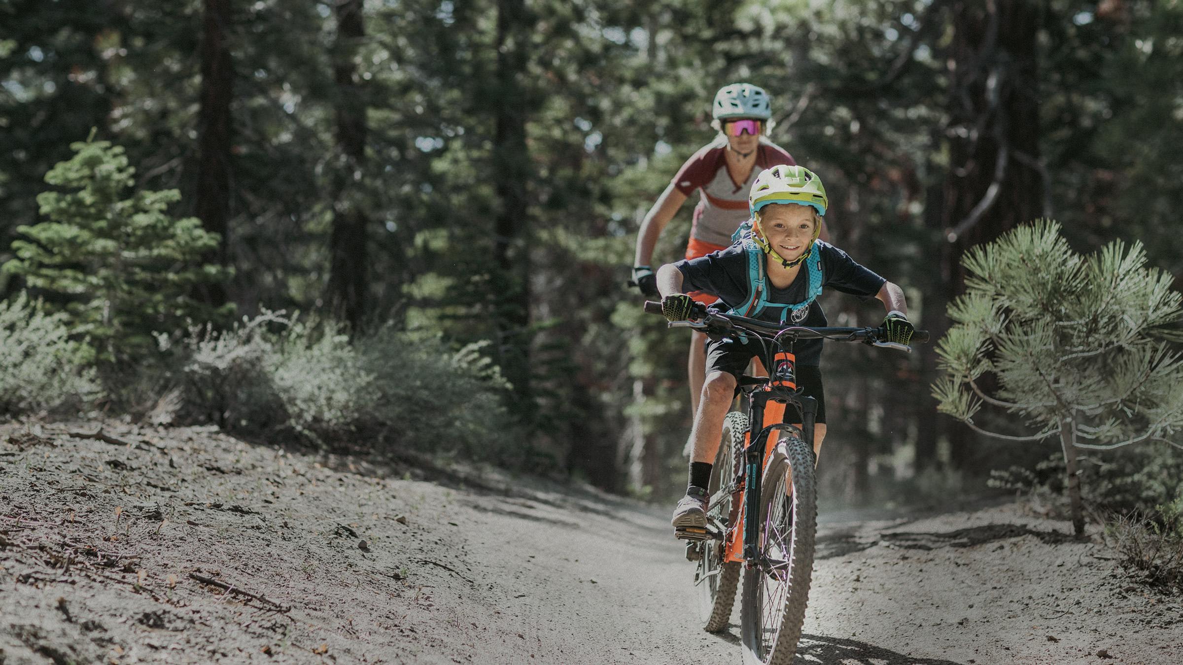 Child and parent riding mountain bikes at Mammoth Bike Park