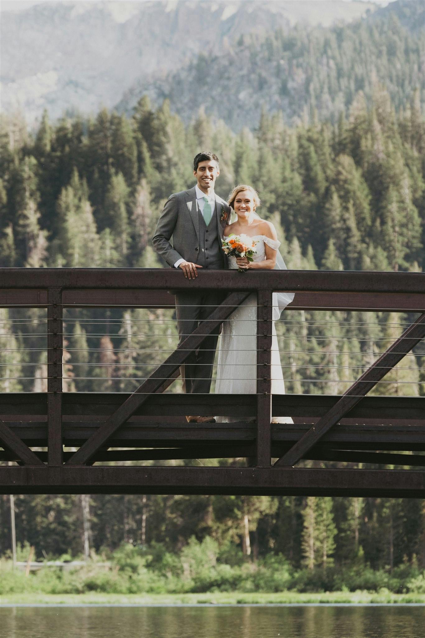 Bride and groom posing for photo on Twin Lakes bridge