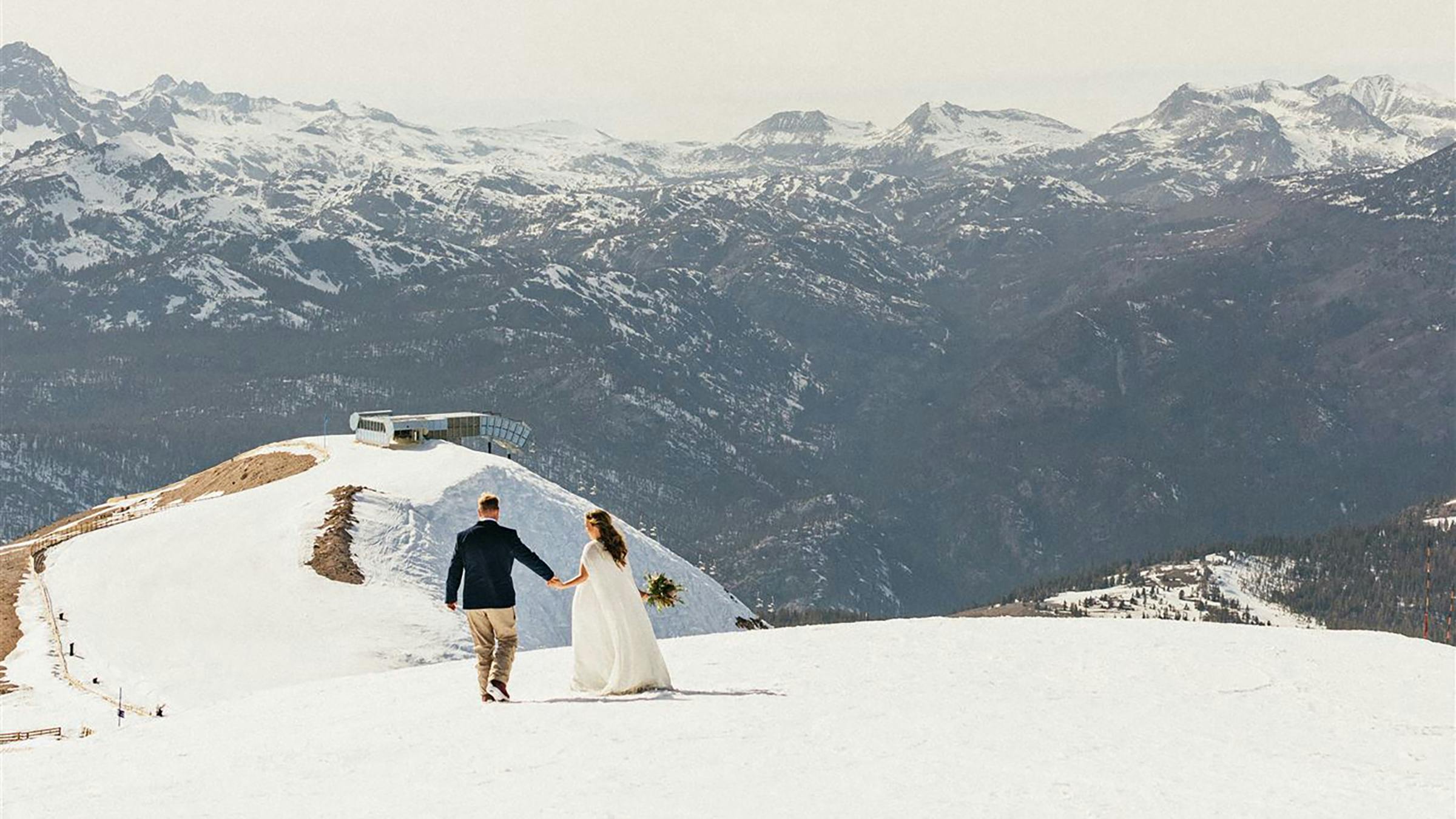 Bride and groom on top of snowy Mammoth Mountain