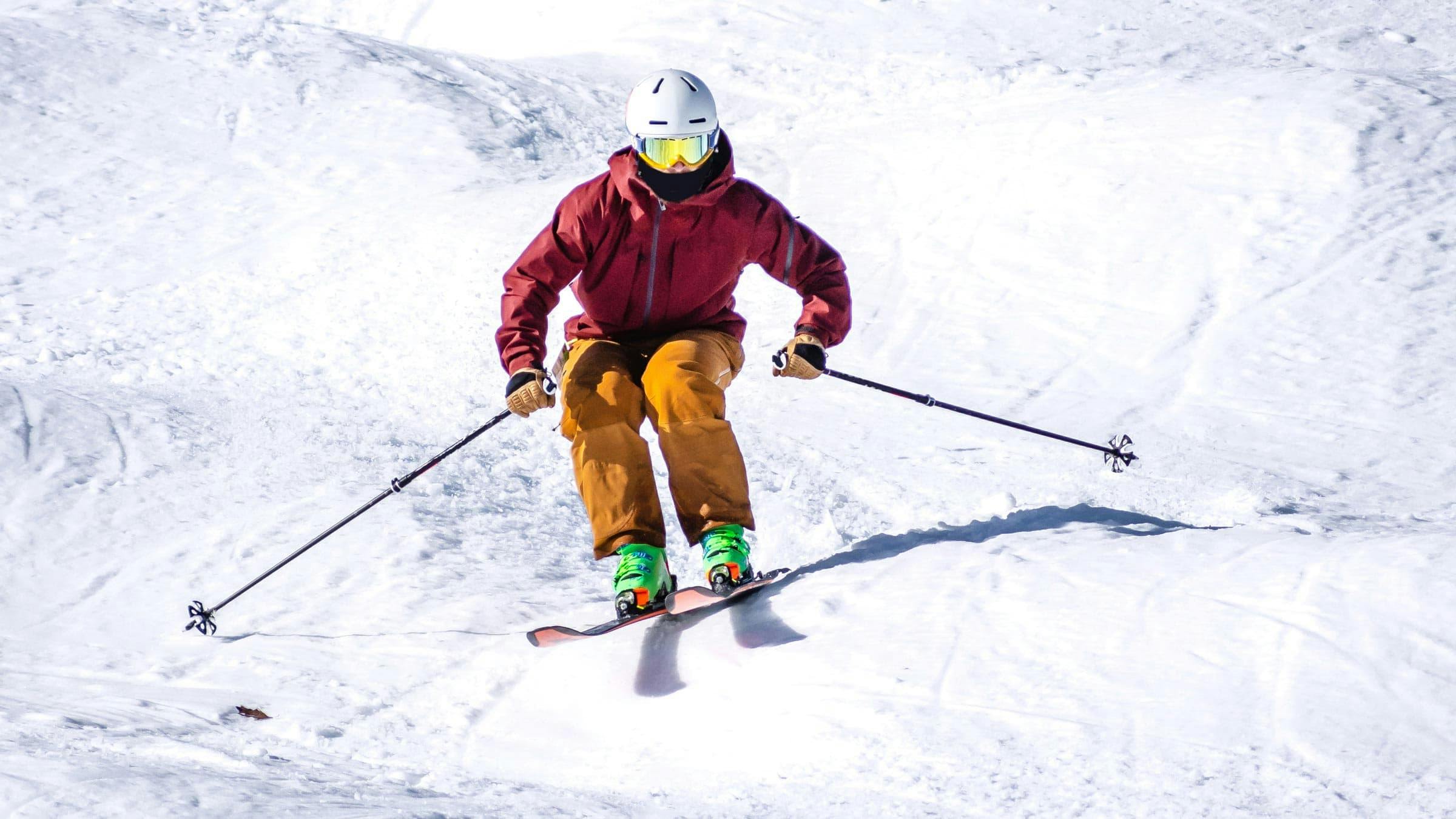 stock image of a man skiing through moguls