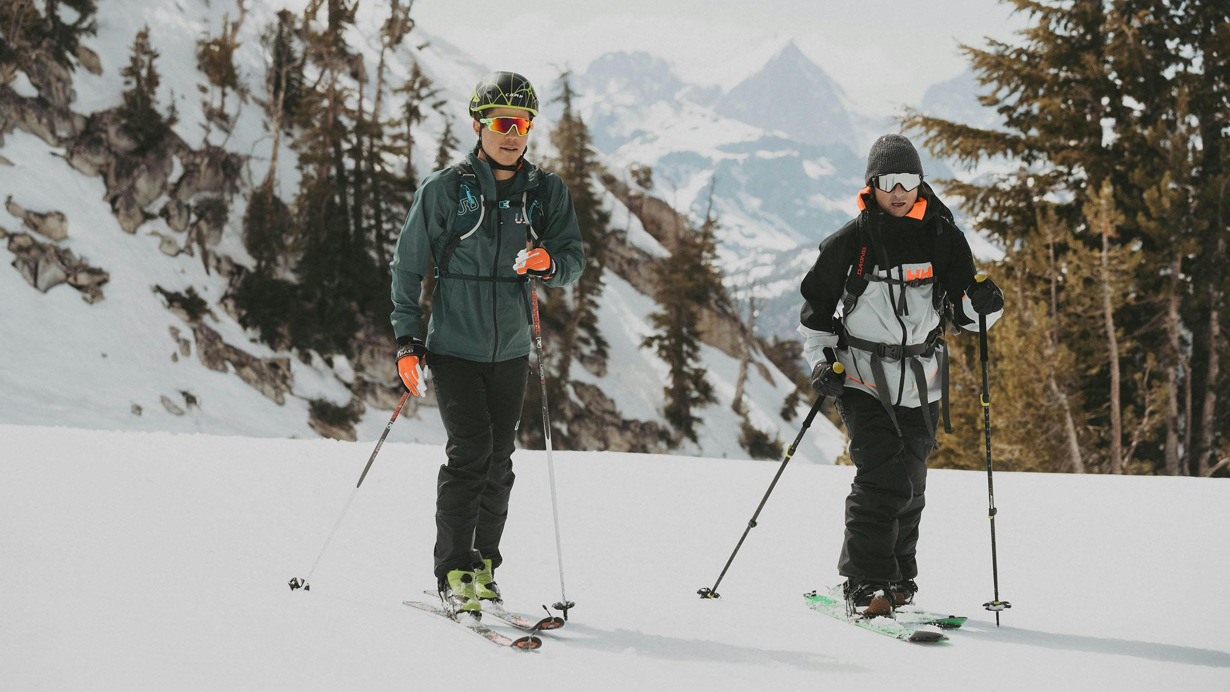 Two skiers skinning uphill
