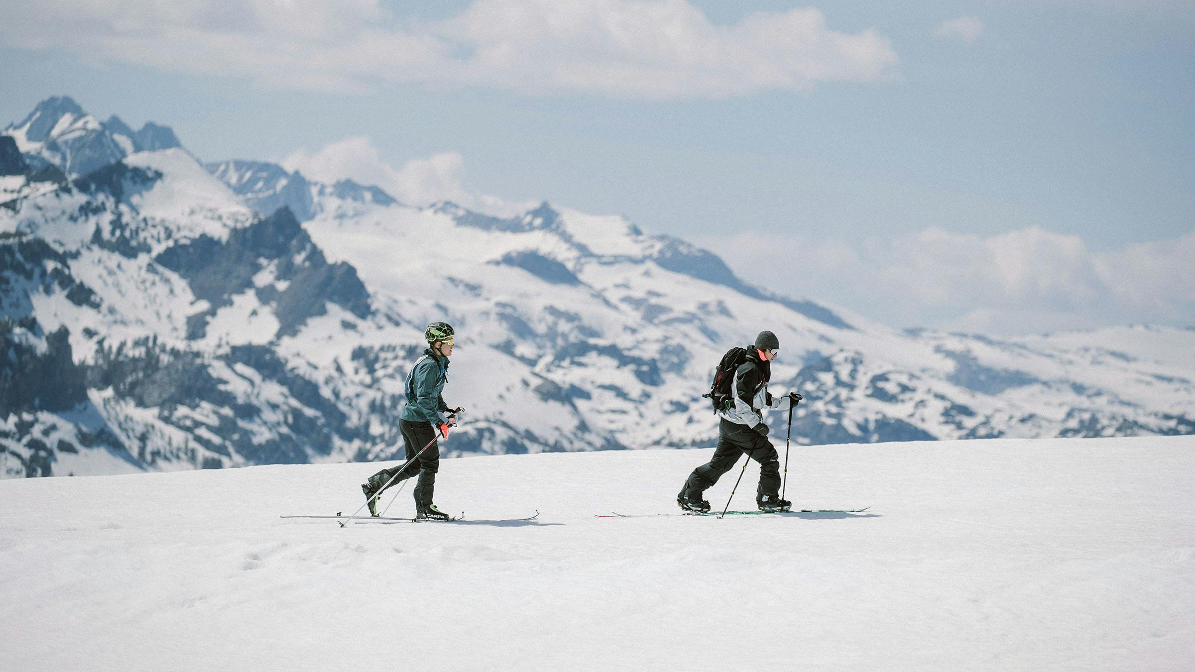 Backcountry skiers with mountains in the background